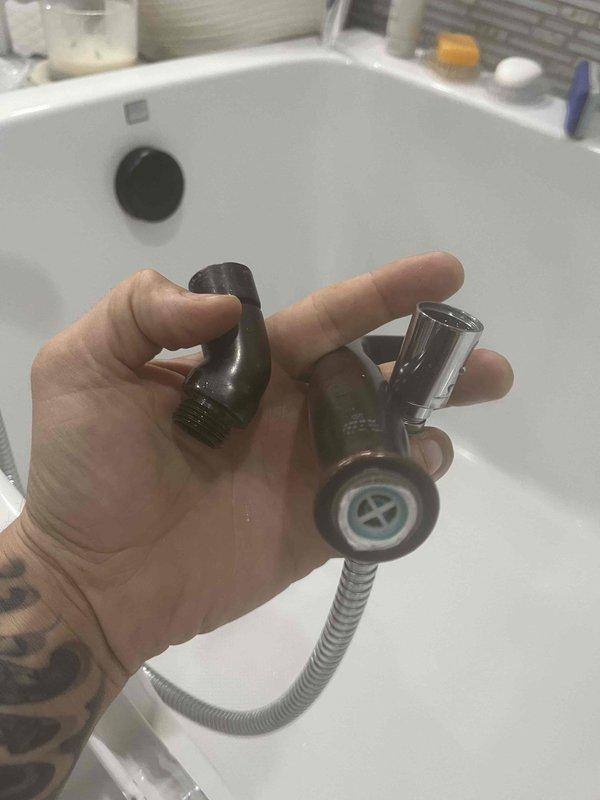 Responded to service call for broken handheld showerhead in master bathroom tub. Removed damaged unit and installed customer-supplied replacement handheld showerhead with flexible metal hose, connecting it to existing tub faucet fixture with oil-rubbed bronze finish. Tested water flow and spray patterns to ensure proper operation and verified secure connections with no leaks.