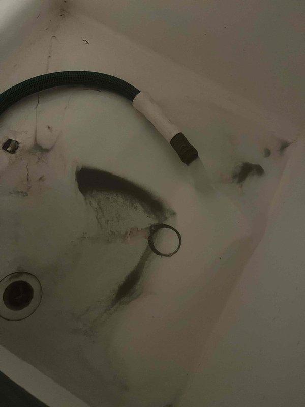 Conducted on-site evaluation of existing water softener system in response to water quality issues and visible staining throughout the home. Assessed current equipment condition, reviewed previous estimate for replacement system, and documented existing plumbing configuration including pipe insulation showing moisture accumulation and basement utility connections. Photographed water staining evidence in fixtures and evaluated overall water treatment needs for property built in 1975.
