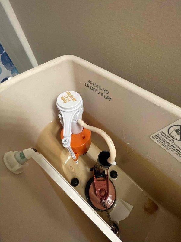 Returned to property to complete fill valve replacement in toilet tank and inspect second toilet as requested. Successfully installed new fill valve assembly, ensuring proper water level adjustment and verifying all connections for leak-free operation. Inspected second toilet fixture, confirmed standard two-piece configuration with existing braided stainless steel supply line and angle stop valve in proper working condition.