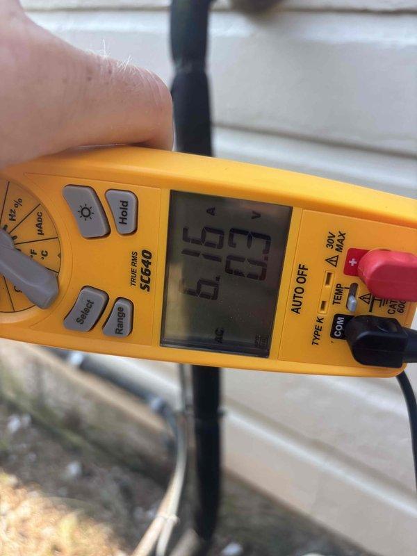 Completed routine cooling maintenance and system diagnostics on residential HVAC unit. Performed electrical measurements using digital multimeter, recording amperage draw of 57.5 amps and verifying proper voltage levels at 265V, confirming system is operating within manufacturer specifications.