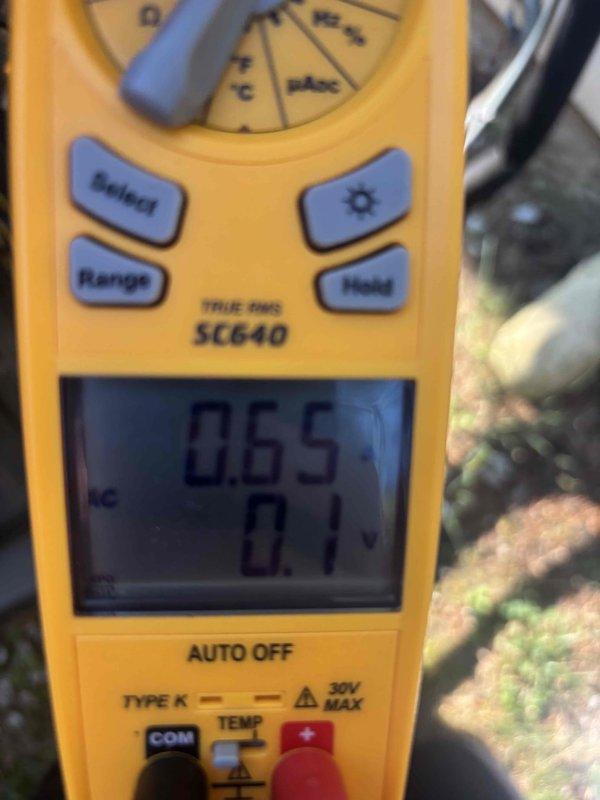 Completed routine cooling maintenance and system diagnostics on residential HVAC unit. Performed electrical measurements using digital multimeter, recording amperage draw of 57.5 amps and verifying proper voltage levels at 265V, confirming system is operating within manufacturer specifications.