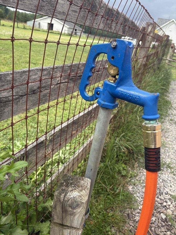 Responded to callback for exterior hose bibb that was previously repaired but continued leaking with increased severity. Upon arrival, inspected outdoor spigot mounted on wooden fence post and identified failure of previous repair attempt. Diagnosed faulty valve mechanism and improper seal causing water discharge. Replaced defective valve assembly, installed new compression washer, and tested spigot under full pressure to verify complete leak elimination. System now functioning properly with no water loss detected.
