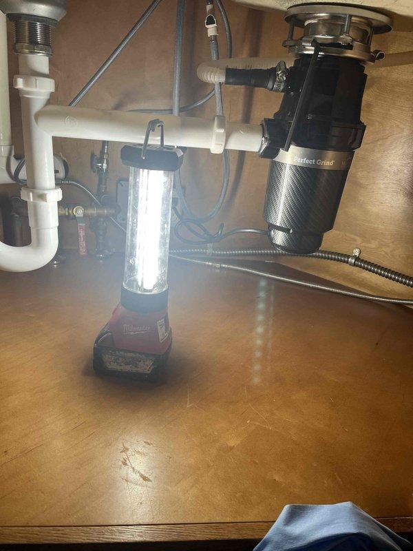 Performed water heater flush on 13-year-old tanked unit and assessed overall condition to help determine remaining service life. Additionally installed new garbage disposal unit under kitchen sink, completing all plumbing connections and verifying proper operation of the disposal system and drain assembly.
