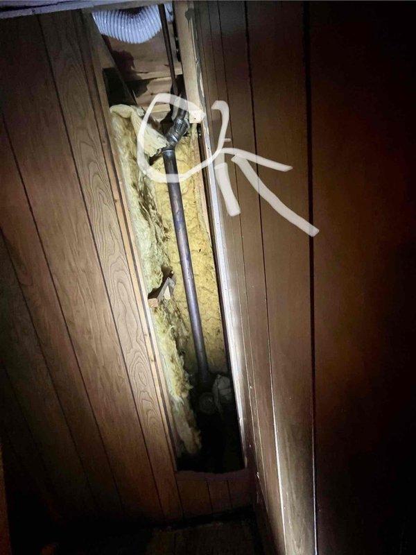 Responded to water leak in basement bathroom with saturated walls and floors. Upon investigation, accessed crawl space and attic areas to identify source of leak. Inspected plumbing components including corroded cast iron drain pipe and fittings showing significant rust and oxidation. Documented deteriorated fiberglass insulation compressed from water exposure. Assessed drainage system connections and flexible ductwork in ceiling cavity. Photographed damaged areas including compromised pipe fittings with visible corrosion and water-stained surfaces for documentation purposes.
