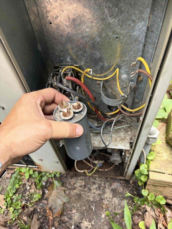 Responded to no-cooling call on Bard 4-ton AC unit that had tripped breaker. Upon inspection, identified failed dual-run capacitor with severe terminal corrosion and oxidation. Replaced defective capacitor, verified proper amperage readings with clamp meter, and confirmed system operation. Unit restored to normal cooling function with breaker holding steady.