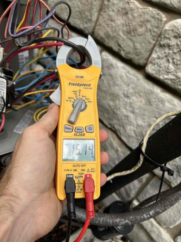 Completed routine cooling maintenance member visit on HVAC system. Performed comprehensive inspection of heat exchanger coil assembly, verifying fin condition and refrigerant line connections. Documented system components with photos showing evaporator coil with aluminum fins and copper U-bend refrigerant distribution lines, noting normal patina on copper tubing consistent with system age. Conducted electrical diagnostics using clamp meter, measuring system amperage at 15.14 amps, which falls within normal operating parameters. Inspected all electrical connections and wiring harness to control board. System operating properly with no issues identified during this scheduled maintenance visit.