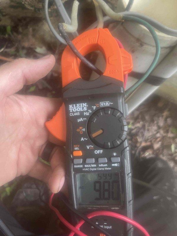 Responded to low water pressure complaint and performed diagnostic inspection of residential water system. Kinetico water treatment company had previously inspected their equipment and determined the issue originated from the well pump system. Conducted electrical testing of well pump circuit using digital clamp meter, which showed a reading of 98 amps, indicating potential pump motor issues. Inspected pressure tank assembly and associated components, including pressure gauge, pressure switch, and piping connections. Pressure gauge readings and visible condition of brass fittings and valve assembly were documented. Findings support determination that well pump is the source of the low pressure condition and will require further service or replacement by well pump specialist.
