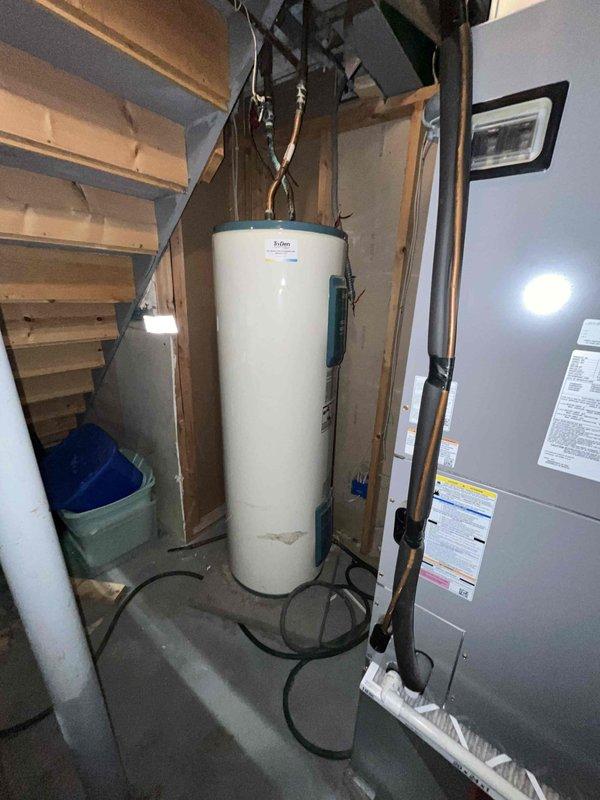 Responded to emergency call for active water leak flooding through ceiling with source identified at toilet. Upon arrival, located and shut off water supply to stop flooding. Inspected toilet assembly and surrounding plumbing connections in bathroom. Assessed water damage extent and verified leak source was isolated. Documented mechanical room equipment and bathroom fixture conditions. Completed emergency service to stop active flooding and prevent further water damage to structure.