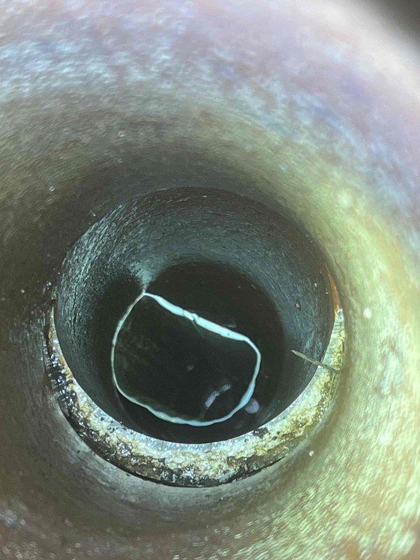 Performed camera inspection of downspout drainage system to investigate reported issues. Camera revealed standing water and mineral deposits within the drainage pipe, indicating potential blockage or improper drainage. Documented findings with aerial property mapping to identify drainage route from downspout connection point to suspected septic and leach field areas for further assessment.