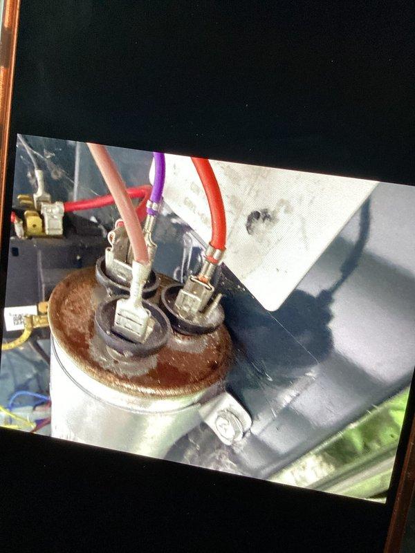 Completed routine AC tune-up maintenance on three air handling units of varying ages (3 years, 9 years, and one unspecified). Performed standard preventive maintenance procedures including system diagnostics, temperature and humidity measurements on return and supply air sides, and visual equipment inspection. Return air measurements recorded at 70.4°F dry bulb with 70.9% relative humidity. Documented component conditions with photographic evidence, noting corrosion present on capacitor terminal connections. All three systems operating properly with no immediate service needs identified at time of visit.