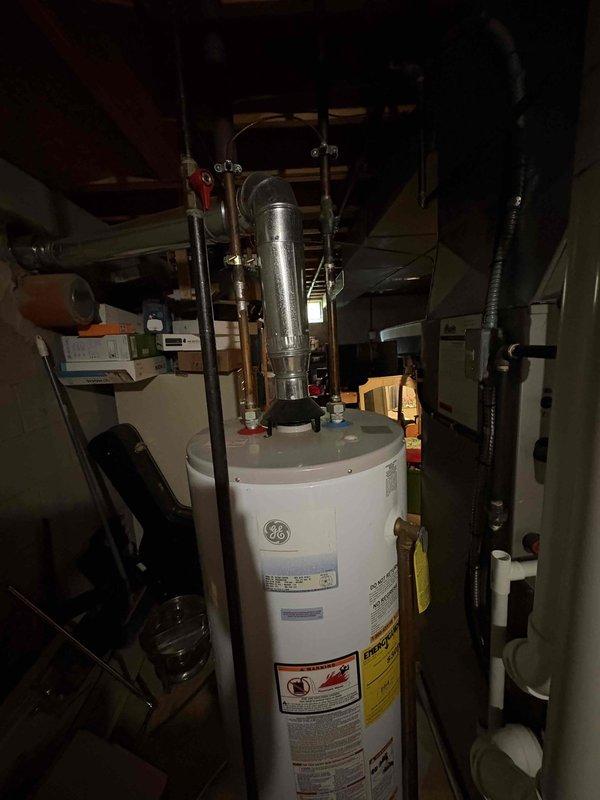 Conducted on-site assessment of existing GE gas tank water heater for replacement estimate. Evaluated current installation including copper supply piping, gas connections, shutoff valve condition, and venting configuration in basement utility area. Documented equipment specifications, surrounding clearances, and necessary connection points to provide accurate replacement proposal.