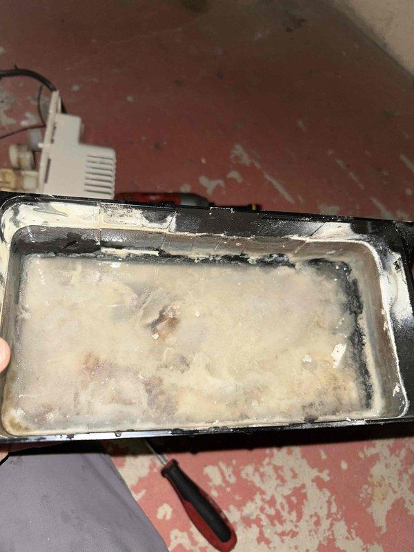 Responded to non-functional condensate pump on air conditioning system. Upon inspection, found pump mechanism heavily contaminated with mineral deposits and biological buildup causing operational failure. Removed and replaced defective condensate pump assembly and cleaned drip pan which contained significant sediment accumulation. System tested and verified proper condensate removal operation restored.