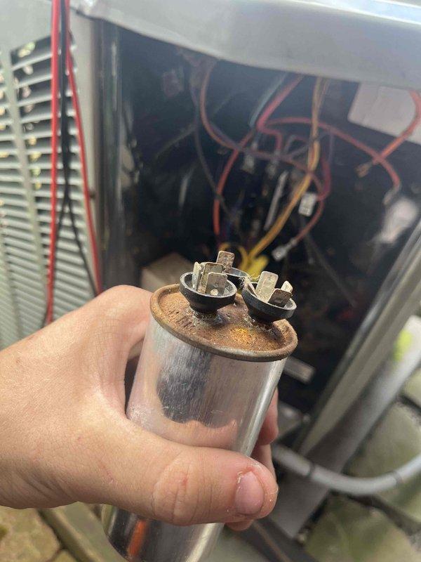 Responded to no-cool call where outdoor unit would not turn on. Upon inspection, found dual capacitor showing significant rust and corrosion on terminals. Removed failed capacitor and replaced with new unit matching proper specifications. Restored power to system, verified compressor and condenser fan operation, and confirmed unit cooling properly.