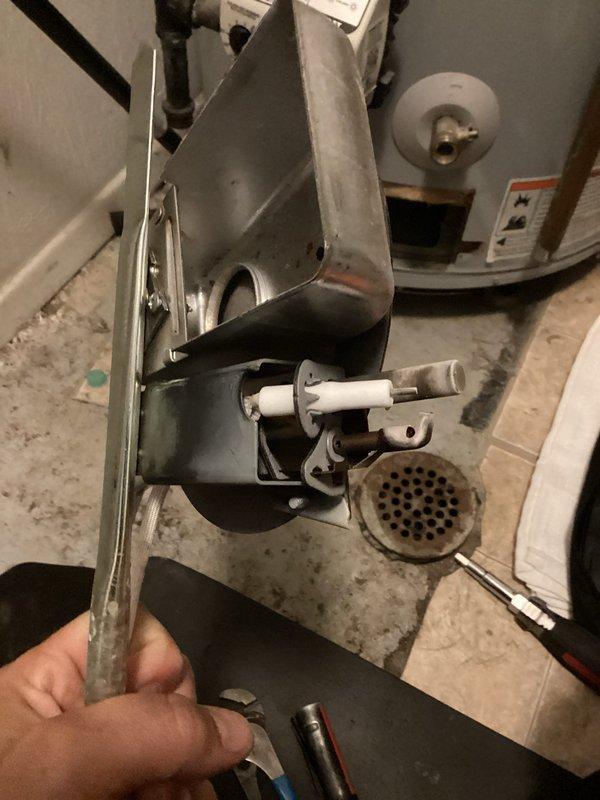 Responded to a no hot water complaint at a forty-year-old residence where the issue had recurred following a previous service visit. Upon inspection of the tanked water heater, identified a failed burner assembly as the root cause of the heating failure. Disassembled and removed the burner assembly, flame spreader screen, and associated ignition components from the combustion chamber. Inspected the burner tube, pilot assembly, and thermocouple for proper operation and wear patterns. Cleaned accumulated debris and sediment from the burner compartment and flame spreader. Replaced the defective burner assembly with new components, ensuring proper alignment and secure mounting. Reinstalled the flame spreader screen and reconnected all gas connections. Tested the pilot ignition system and main burner operation to verify proper flame characteristics and consistent heating. Confirmed hot water delivery throughout the home and verified temperature settings were appropriate. System restored to 