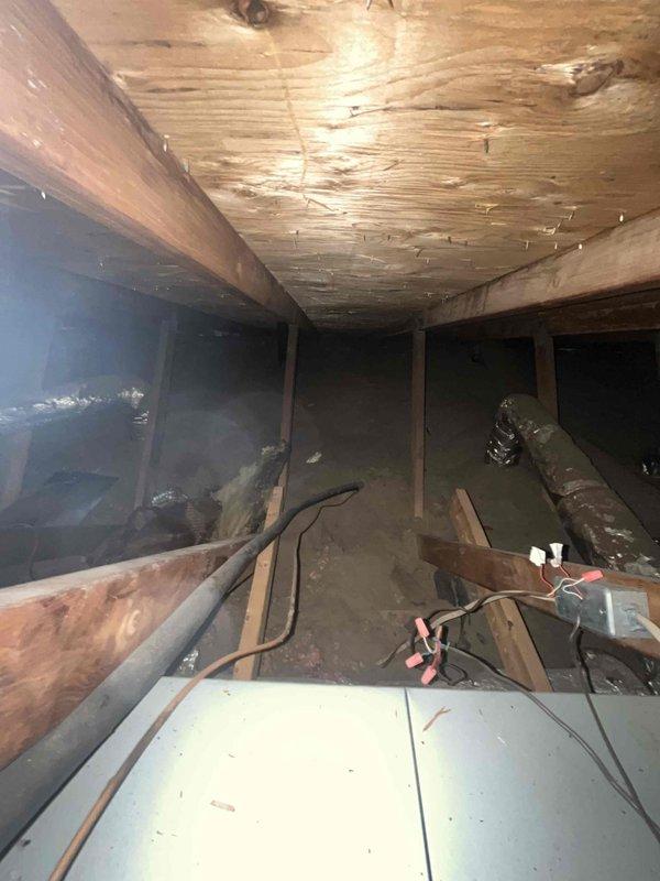 Conducted site assessment for heat pump installation feasibility in residential property. Evaluated existing attic-mounted HVAC infrastructure including flexible ductwork routing, electrical wiring configuration, and available space for equipment placement. Documented current system layout and structural conditions to determine compatibility with heat pump conversion. Noted previous electrical wire damage requiring repair from neighboring property work. Provided comprehensive estimate for complete heat pump replacement system including necessary electrical corrections and integration with existing duct infrastructure.