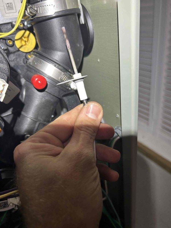 Responded to no heat call for furnace with intermittent heating operation. Upon inspection, discovered flame sensor was reading high temperature of 299°F, indicating excessive buildup preventing proper flame detection. Removed and cleaned flame sensor probe to restore proper conductivity and flame sensing capability. Verified sensor reinstallation and tested system through multiple heating cycles to confirm reliable ignition and continuous operation. System restored to normal heating function.