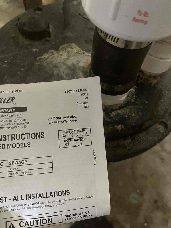 Completed comprehensive sump pump inspection and service on existing Zoeller M53 sewage pump system originally installed in 2012. Verified pump operation, checked discharge piping and check valve functionality, tested float switch mechanism, and inspected electrical connections and control box. Updated service documentation on discharge pipe with current inspection date for maintenance tracking purposes.