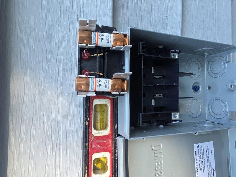 Completed air conditioning installation at residential property. Installed outdoor condensing unit with proper electrical disconnect box containing TR125 fuses and appropriate wiring connections. Verified electrical panel was leveled and securely mounted to exterior siding. All components installed per manufacturer specifications and local electrical codes. System tested and confirmed operational upon completion.