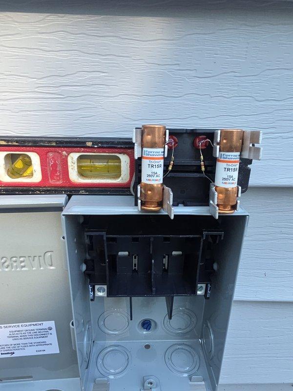 Completed air conditioning installation at residential property. Installed outdoor condensing unit with proper electrical disconnect box containing TR125 fuses and appropriate wiring connections. Verified electrical panel was leveled and securely mounted to exterior siding. All components installed per manufacturer specifications and local electrical codes. System tested and confirmed operational upon completion.