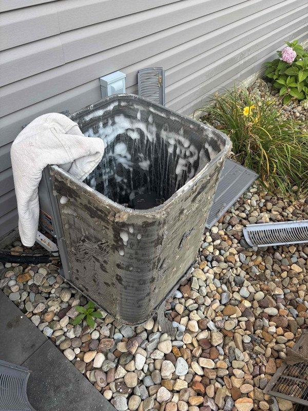 Completed outdoor condenser coil cleaning service on residential HVAC unit. Upon arrival, found condenser coil fins heavily contaminated with dirt, dust, and environmental debris causing reduced airflow and heat transfer efficiency. Thoroughly cleaned aluminum fin assembly using appropriate coil cleaning solution and techniques to remove accumulated buildup. Restored coil to optimal operating condition, improving system performance and energy efficiency.