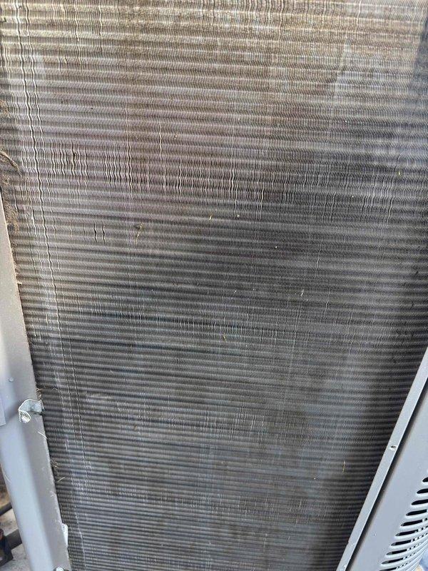 Completed outdoor condenser coil cleaning service on residential HVAC unit. Upon arrival, found condenser coil fins heavily contaminated with dirt, dust, and environmental debris causing reduced airflow and heat transfer efficiency. Thoroughly cleaned aluminum fin assembly using appropriate coil cleaning solution and techniques to remove accumulated buildup. Restored coil to optimal operating condition, improving system performance and energy efficiency.