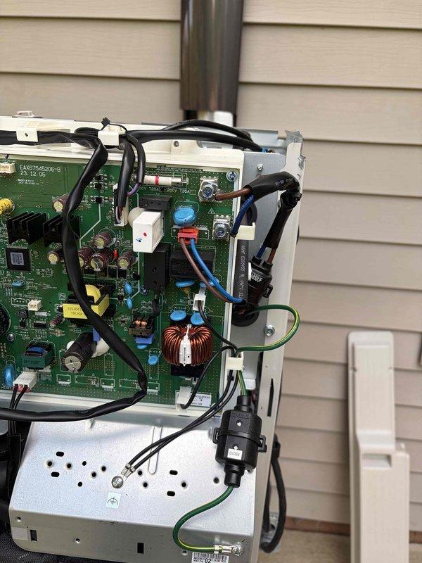 Completed warranty service call on outdoor HVAC unit. Accessed control panel and inspected electronic control board assembly, internal wiring harnesses, and electrical connections. Verified proper operation of circuit board components including capacitors, inductors, and integrated circuits. Inspected refrigerant line connections and routing. Checked all wire terminations, bundled cable assemblies, and grounding connections for secure attachment. Examined power supply module and control board mounting. Reassembled unit and verified system functionality.