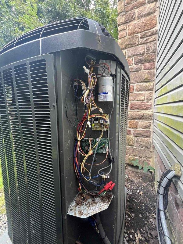 Returned to property to perform leak search on air handler unit as previously sold. Accessed outdoor condensing unit and inspected all refrigerant connections, electrical components, and internal assemblies. Conducted thorough visual inspection of compressor, capacitor, contactors, and control board. Examined refrigerant lines and fittings for signs of oil residue or corrosion that would indicate refrigerant leakage points. Documented unit condition with photographs showing interior components and wiring configuration for service records.