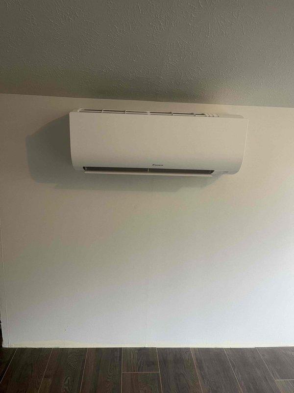Completed installation of a single-head Daikin mini-split system. Installed indoor wall-mounted evaporator unit, ran refrigerant line set with proper insulation, made copper pipe connections using brass compression fittings, and routed electrical and drain lines through conduit. System was tested and confirmed operational.