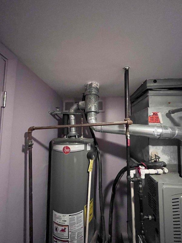Responded to concerns regarding damp carpets and mildew odor in basement area potentially related to two-year-old furnace system. Conducted thorough inspection of furnace and surrounding mechanical equipment, including water heater and associated plumbing connections. No active water leakage detected from furnace unit or condensate drainage system. Documented existing mechanical room conditions with photographic evidence showing furnace installation, water heater, venting configurations, and exterior foundation area. Provided replacement options and recommendations for system evaluation to address moisture concerns and indoor air quality issues.