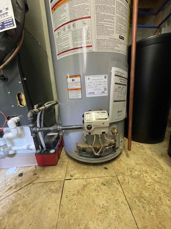 Completed installation of residential tanked water heater system in mechanical room, including all necessary connections and safety components. Installed expansion tank rated at 60 PSI with proper copper piping connections, condensate pump with PVC drainage system, and gas control valve assembly with copper supply lines. All components were properly mounted, labeled, and tested to ensure compliance with plumbing codes and manufacturer specifications.