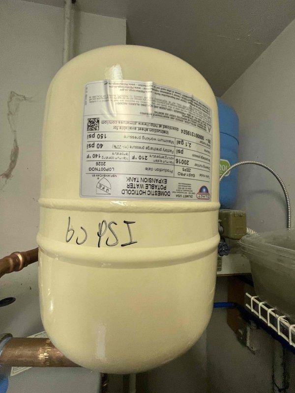 Completed installation of residential tanked water heater system in mechanical room, including all necessary connections and safety components. Installed expansion tank rated at 60 PSI with proper copper piping connections, condensate pump with PVC drainage system, and gas control valve assembly with copper supply lines. All components were properly mounted, labeled, and tested to ensure compliance with plumbing codes and manufacturer specifications.