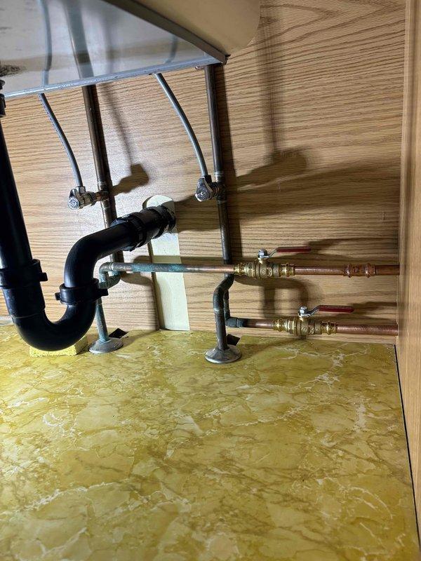 Completed callback service to install toilet seat and replace washing machine supply hose. Installed new toilet seat on existing two-piece toilet in bathroom with mosaic tile flooring. Replaced flexible braided water supply line beneath bathroom vanity cabinet, connecting to shutoff valve with proper fittings. Verified all connections for proper operation and absence of leaks. Work area left clean and fixtures functioning properly.