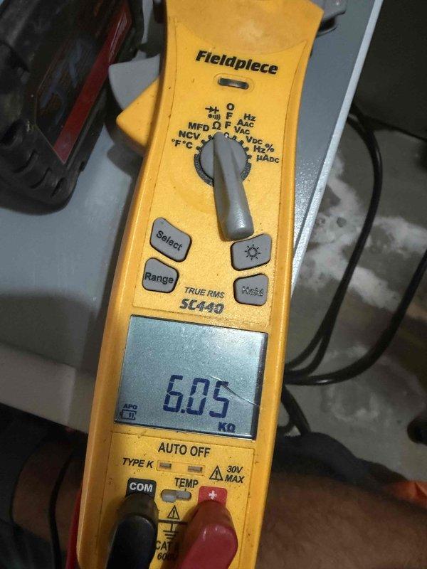 Responded to ongoing E5 error code on dehumidifier system. Performed diagnostic testing of humidity sensor circuit by measuring resistance across sensor wire terminals on control board per manufacturer troubleshooting protocol. Resistance reading of 6.05 kΩ was obtained using digital multimeter and compared against factory resistance chart specifications. Documented findings with photos of testing procedure and meter readings for service history reference.