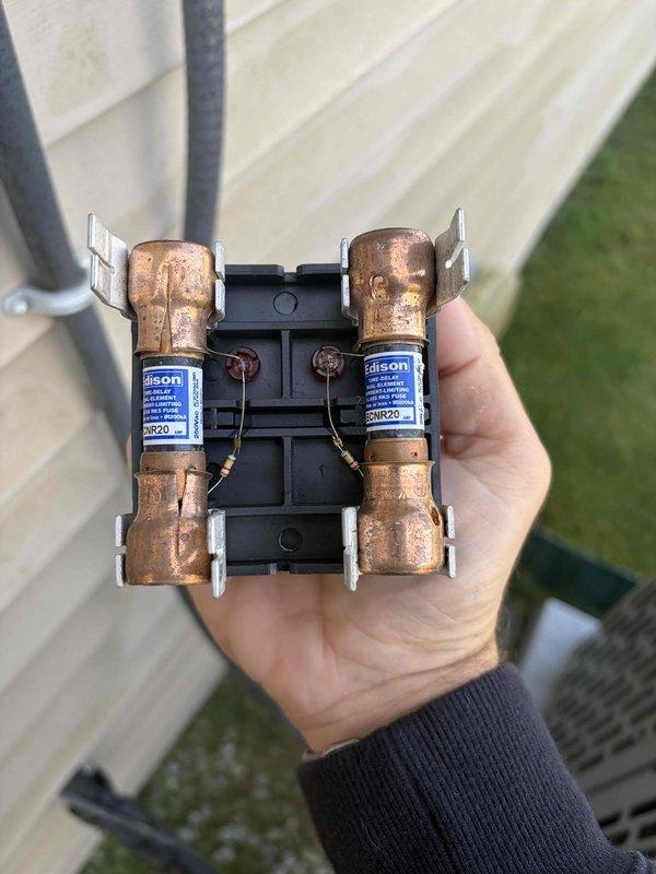 Completed cooling maintenance member visit to address thermostat difficulties following a power outage. Performed comprehensive system inspection including evaluation of dual valve assembly and blower motor components. Inspected and photographed dual Tilson valve assembly with copper bodies mounted on black bracket, confirming proper valve operation and connections. Examined blower wheel assembly, noting normal dust accumulation on centrifugal fan blades and verified proper mounting hub condition. Reset thermostat programming after power outage and restored system to normal operation.