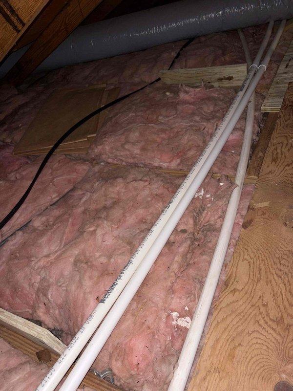 Responded to emergency call for non-operational air conditioning system following previous technician visit on two-month-old equipment. Upon arrival, inspected attic-mounted HVAC unit and discovered improper installation with equipment not level, as evidenced by bubble level readings showing significant deviation from horizontal plane. Corrected unit leveling to manufacturer specifications, verified proper condensate drainage through PVC drain lines, checked refrigerant levels, and tested system operation. Unit now cooling properly with no further issues detected.
