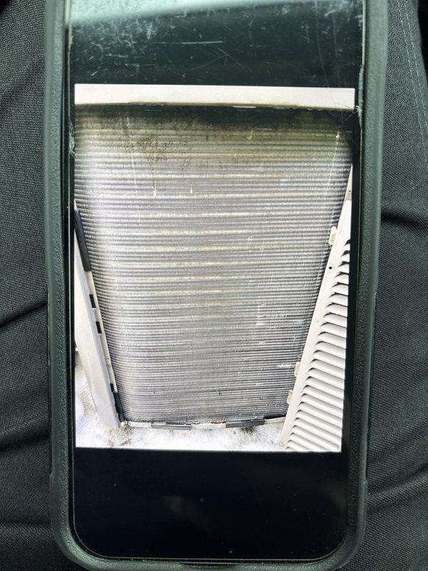 Completed Level 2 outdoor coil cleaning on HVAC system. Evaporator coil showed significant dust, dirt, and debris accumulation with thick matted buildup throughout the unit and on metallic fins. Thoroughly cleaned and restored coil to proper operating condition to improve system efficiency and airflow.