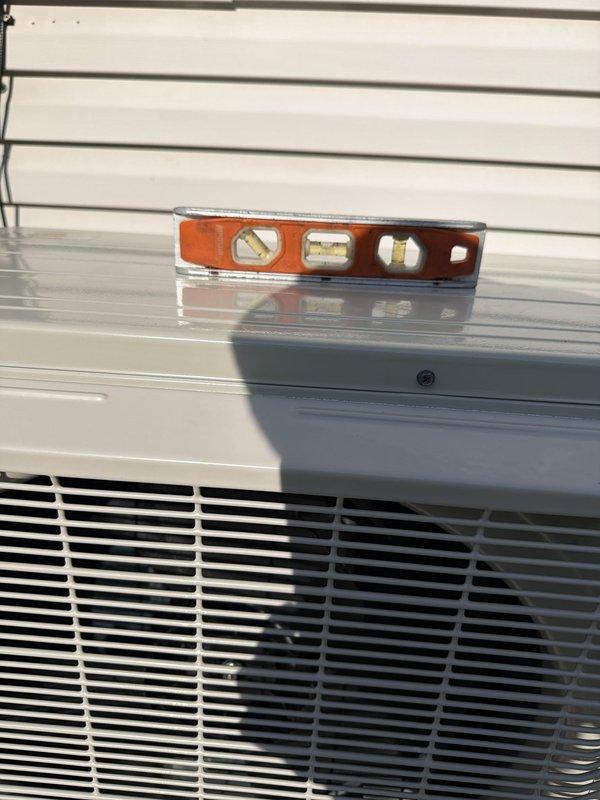 Completed full HVAC system installation including outdoor condensing unit and indoor components. Verified proper unit leveling, tested system operation, and confirmed temperature readings at 1.5°F on refrigerant lines, indicating successful startup and proper refrigerant flow through the system.