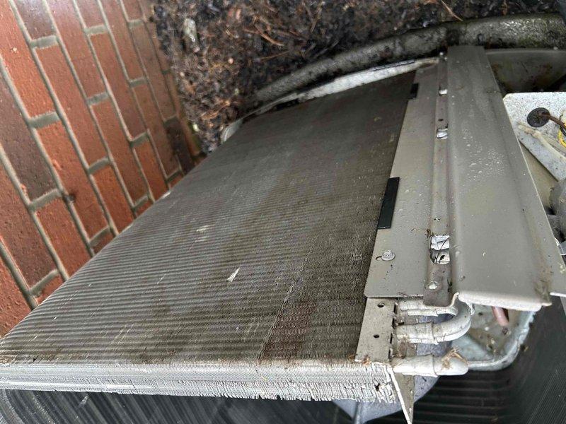 Completed routine cooling maintenance member visit on residential air conditioning system. Performed comprehensive inspection of outdoor condensing unit, which showed significant accumulation of dirt, grime, and biological growth on exterior cabinet surfaces. Cleaned condenser coil fins that displayed heavy buildup of dust, debris, and environmental contaminants affecting heat transfer efficiency. 

Discussed equipment protection options with homeowner, specifically addressing voltage line monitors and soft start devices for the air conditioning system. Voltage line monitors provide protection against power surges and voltage fluctuations that can damage compressor and electronic components. Soft start technology reduces electrical demand during compressor startup, minimizing stress on system components and electrical infrastructure while extending equipment lifespan.

Documented unit condition through photographs showing exterior cabinet deterioration, organic growth on metal surfaces