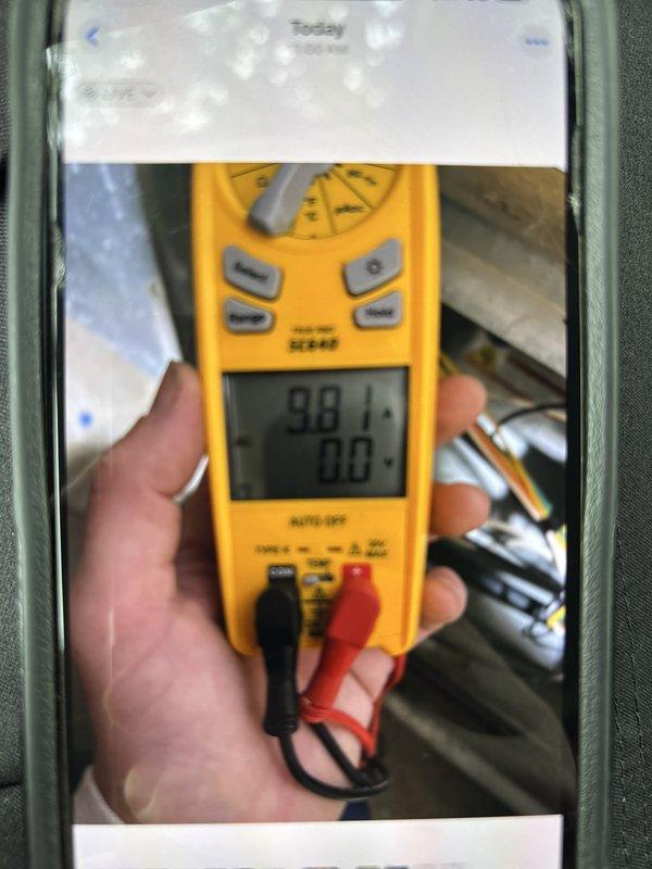 Completed routine cooling maintenance member visit on air handler system. Performed system diagnostics using digital multimeter, recording temperature readings of 98.1°F, and verified proper electrical operation with all measurements at 0.0 variance. Documented equipment identification tag and model information for service records.