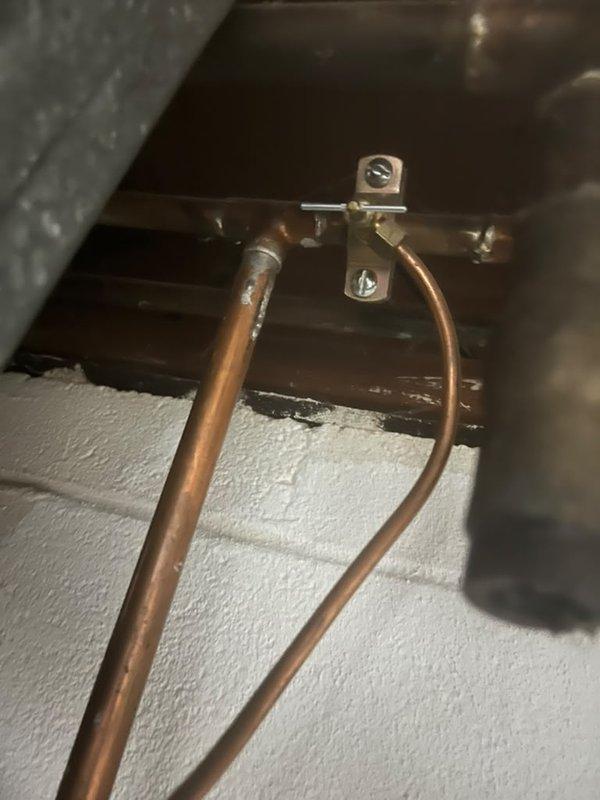 Installed and secured valve assembly as part of larger plumbing system integration. Mounted copper refrigerant lines to metal ductwork using appropriate brackets and hardware, ensuring proper positioning and support of pipes throughout the installation area. Applied spray foam insulation to foundation surfaces to complete thermal envelope requirements for the system.