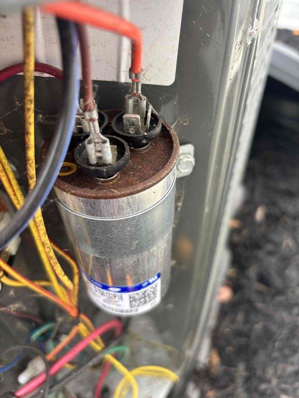 Performed routine cooling maintenance member visit on air handler system. Inspected and tested dual run capacitor, which showed signs of corrosion and oxidation on terminal connections; verified electrical readings at 177.1 volts using clamp meter to ensure proper system operation. All refrigerant line connections and electrical components were evaluated for performance and safety compliance during this scheduled maintenance inspection.