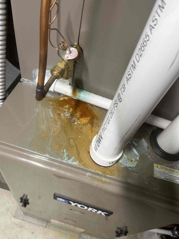 Responded to service call reporting sewer gas odor throughout residence, incomplete toilet flushing, and non-operational sump pump. Upon inspection, discovered multiple plumbing issues including a leaking sink drain connection with visible water damage and staining at the basin interface. Identified standing water with rust-colored contamination in HVAC condensate drain pan, indicating drainage system complications. Addressed water intrusion issues and restored proper drainage function to affected plumbing systems.