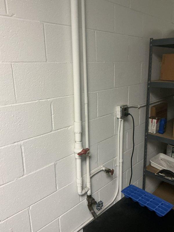 Performed commercial backflow prevention testing on PVC and metal piping assembly in utility room. Standard testing procedures completed on accessible backflow devices with red ball valves; vault testing requiring OSHA safety protocols was assessed and priced separately onsite due to confined space entry requirements. Documentation and photographic records captured of existing plumbing infrastructure including water meter connections and valve configurations.