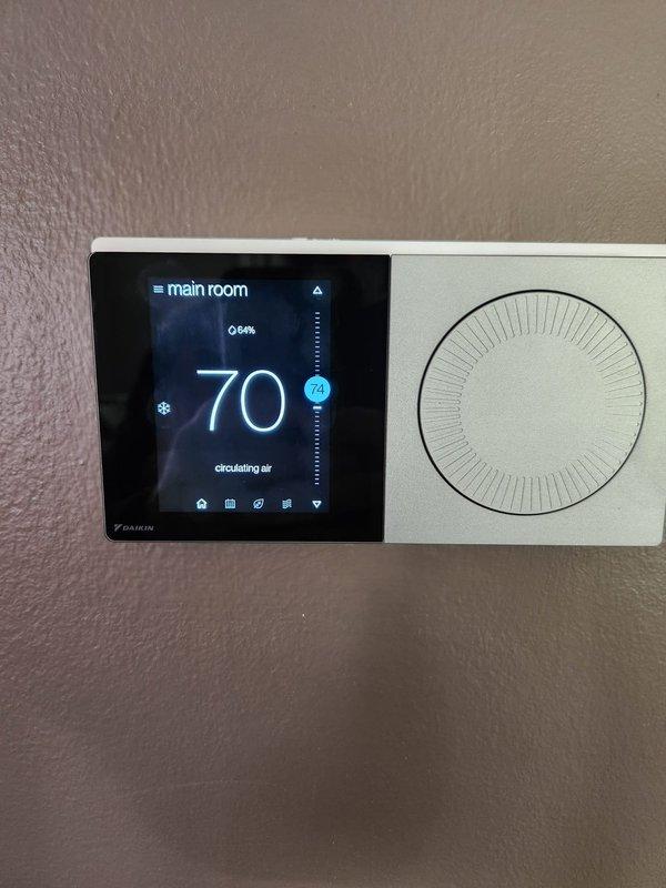 Returned to address warranty concerns with Daikin system not reaching setpoint and remote sensor pairing issues. Installed new line voltage monitor in exterior junction box and replaced malfunctioning remote sensor that would not enter pairing mode. Verified thermostat communication, confirmed system operation with proper temperature differential, and validated all components functioning correctly with unit now maintaining desired temperature settings.