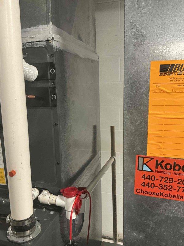 Responded to callback for odor complaint following previous day's air handler installation. Inspected newly installed HVAC system in basement mechanical room, including air handler unit, ductwork connections, and drainage piping. Photographed installation to document equipment placement and verify proper installation of PVC condensate lines, flexible ductwork, and electrical conduit. Confirmed all components were properly secured and connected per manufacturer specifications. System operational with no visible defects or installation issues identified.