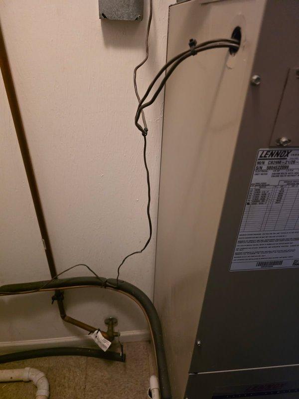 Responded to no heat call on Lennox furnace system. Upon arrival, performed diagnostic inspection of unit located in interior utility closet. Examined manufacturer specification label to determine equipment age and model information. Conducted visual inspection of system components including ductwork connections and cabinet assembly. Noted evidence of deterioration and discoloration at junction where insulated supply duct meets furnace housing, indicating possible historical moisture intrusion or condensation issues. Documented equipment condition and system configuration with photographs for service records. Assessed overall system operation and component integrity to determine cause of heating failure reported from previous winter season.