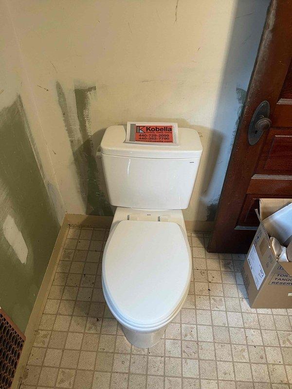 Removed existing toilet fixture showing signs of wear and staining and installed new Toto Drake elongated standard height toilet. Completed full installation including wax ring seal, floor bolts, and water supply connection, ensuring proper function and leak-free operation.