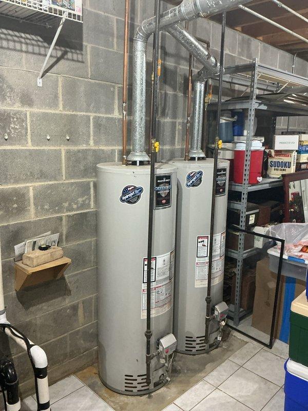 Provided estimate for installation of Navien NPE-240A2 tankless water heater at recently purchased residence. Site assessment documented existing equipment consisting of two tank-style water heaters with gas connections and metal venting systems currently installed in basement utility area. Customer seeking upgrade to tankless system; no existing equipment issues reported at time of evaluation.