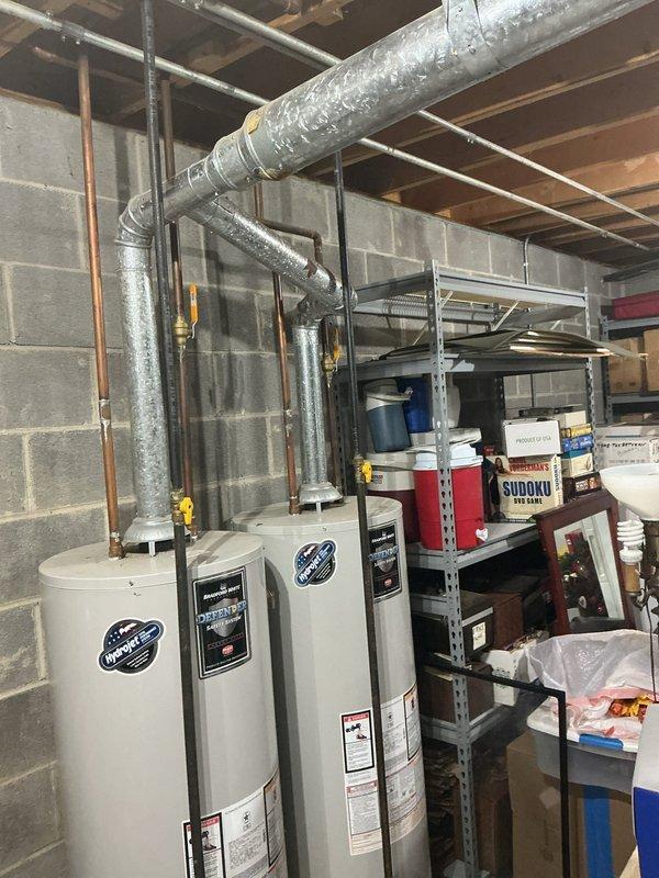Provided estimate for installation of Navien NPE-240A2 tankless water heater at recently purchased residence. Site assessment documented existing equipment consisting of two tank-style water heaters with gas connections and metal venting systems currently installed in basement utility area. Customer seeking upgrade to tankless system; no existing equipment issues reported at time of evaluation.