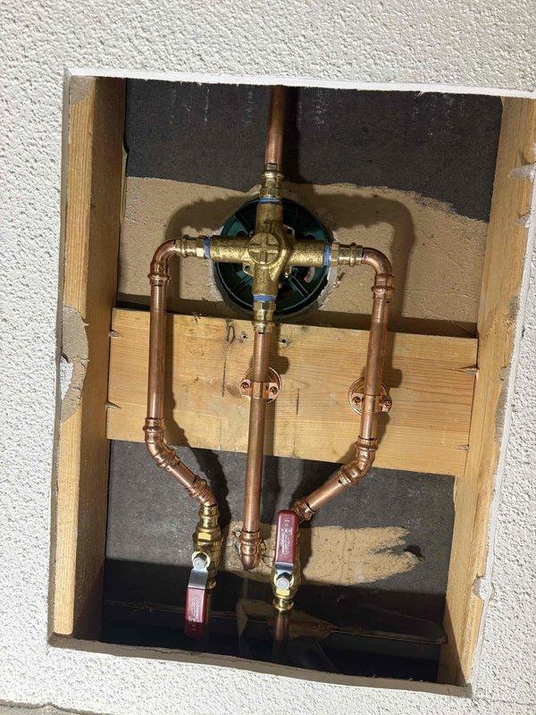 Responded to shower faucet cartridge removal issue where homeowner's DIY replacement attempt resulted in a stuck or broken cartridge. Accessed plumbing assembly through wall opening, assessed copper supply line configuration and valve system, and successfully extracted remaining cartridge components. Installed new single-handle shower cartridge, tested operation and water flow, verified proper temperature control, and restored wall access panel upon completion.